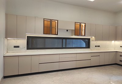 Modular kitchen in cream laminate with stone counter