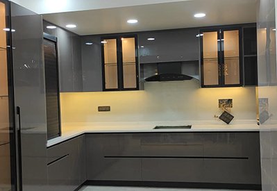 Grey high-gloss modular kitchen with glass wall units